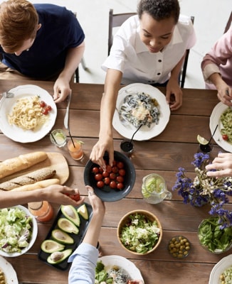 A family sitting around the table, enjoying food